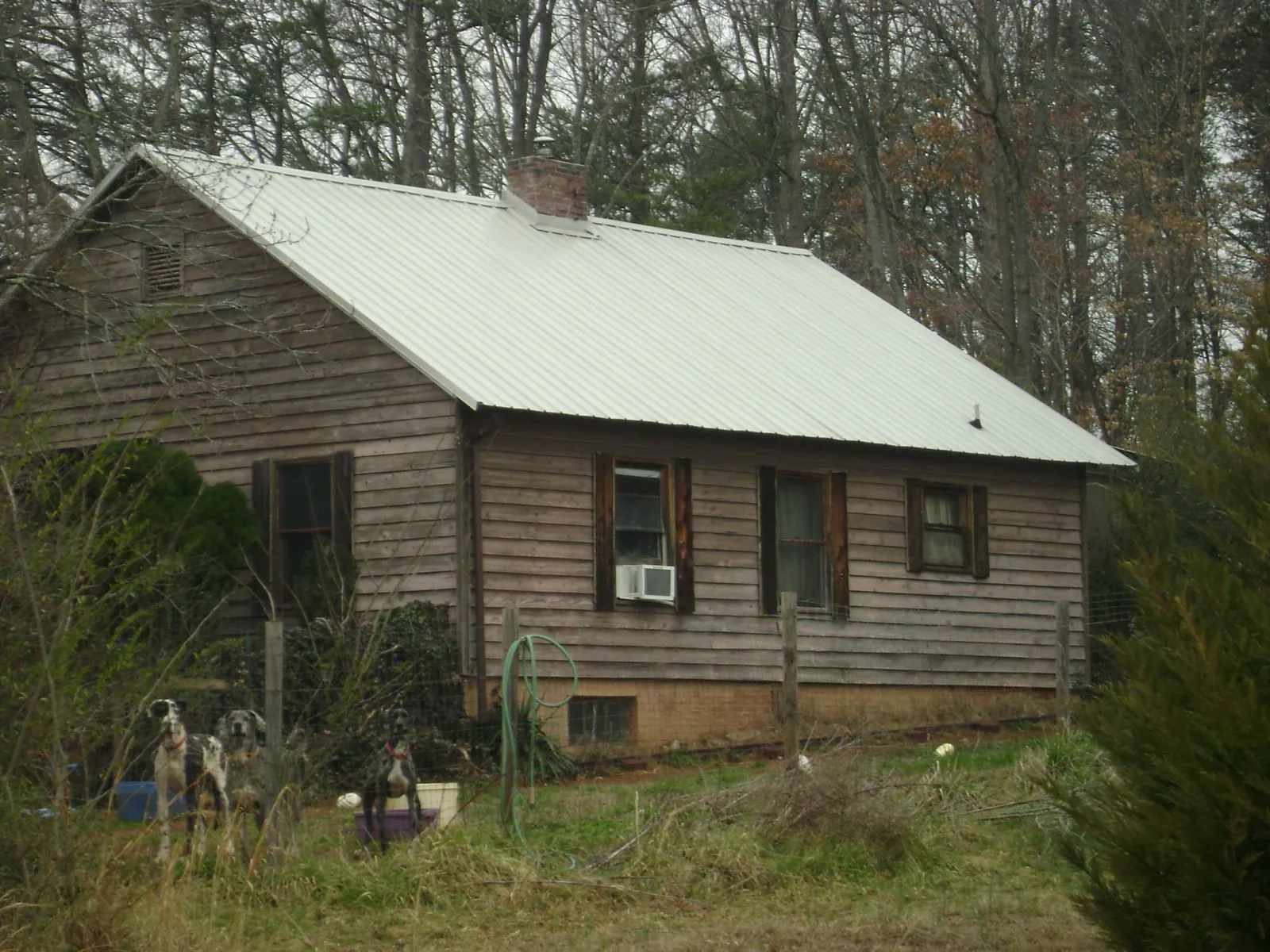 White metal roof on an old wood sided farmhouse, from a Metal Roof Installation job in Petersburg